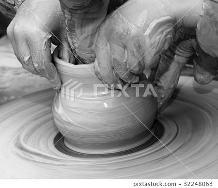 Beginner and teacher in process of making bowl 32248063