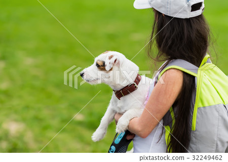 Little happy girl with doggy in hands, summer Little happy girl with doggy in hands, summer 32249462