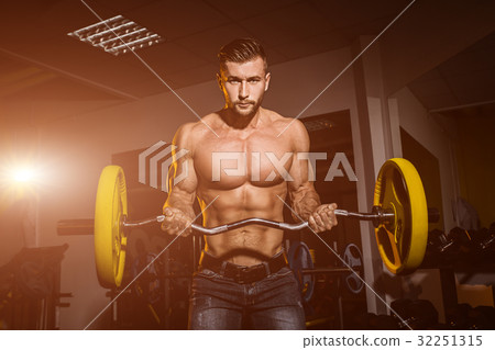 man in gym. Muscular bodybuilder guy doing man in gym. Muscular bodybuilder guy doing 32251315