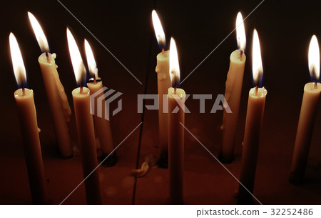 Candle lighted up at night in dark 32252486