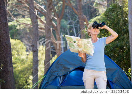Mature woman looking on binoculars 32253498