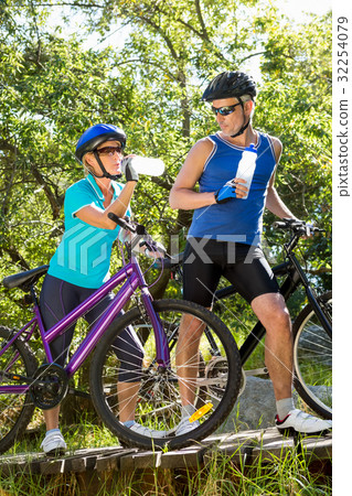 Senior couple standing with their bikes Senior couple standing with their bikes 32254079