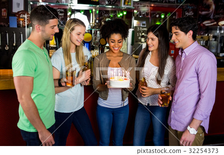 Friends celebrating with cake Friends celebrating with cake 32254373