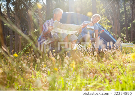 Senior couple relaxing beside their tent 32254890
