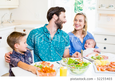 Family having meal in kitchen 32255403