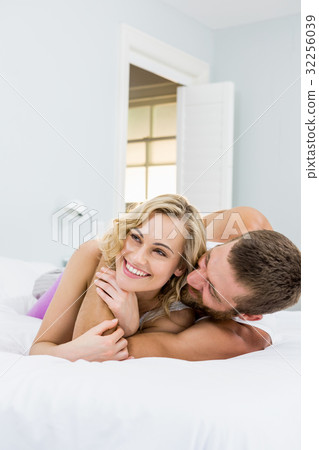 Young couple embracing on bed Young couple embracing on bed 32256039
