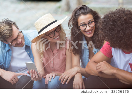 Friends interacting with each other 32256176