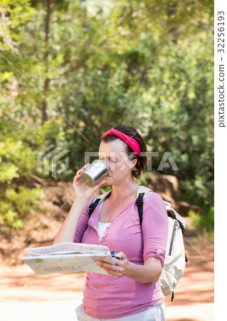 senior woman is reading and drinking senior woman is reading and drinking 32256193