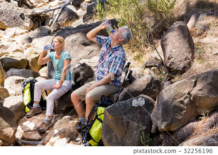 senior couple sitting on stones senior couple sitting on stones 32256196