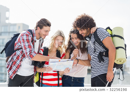 Friends looking at map 32256198