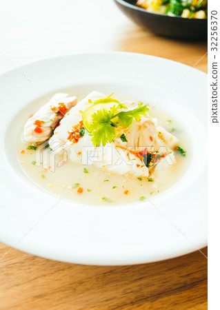 Steam fish fillet meat with lemon spicy sauce 32256370