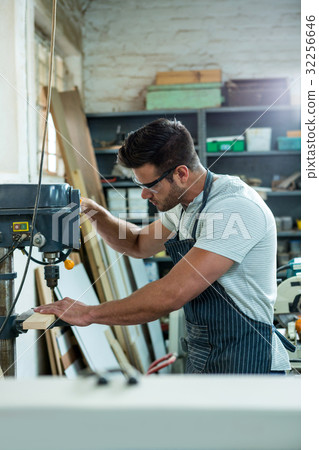 Carpenter using a drill Carpenter using a drill 32256646