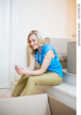 Young woman text messaging on mobile phone 32256838