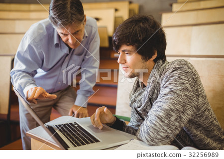 Professor helping a student in classroom Professor helping a student in classroom 32256989