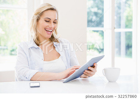 Smiling woman using digital tablet 32257860