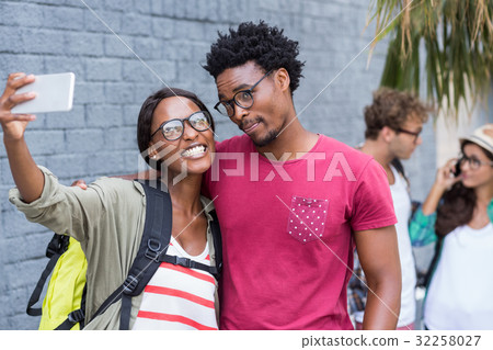 Couple taking selfie on a mobile phone Couple taking selfie on a mobile phone 32258027