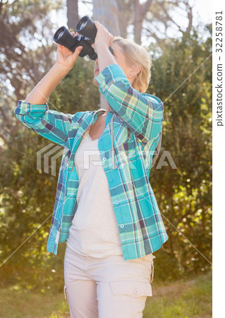 Mature woman looking on binoculars Mature woman looking on binoculars 32258781