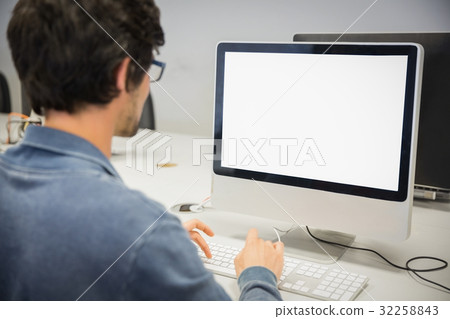 Rear view of student using computer 32258843