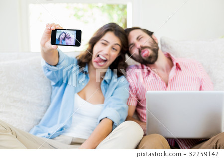 Couple taking a selfie on mobile phone 32259142