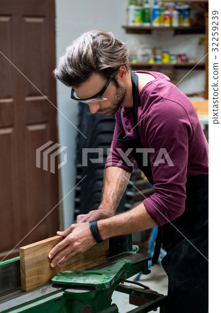 Carpenter working on his craft 32259239