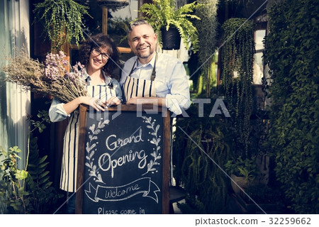 Adult Man and Woman Standing with Grand Opening Sign 32259662