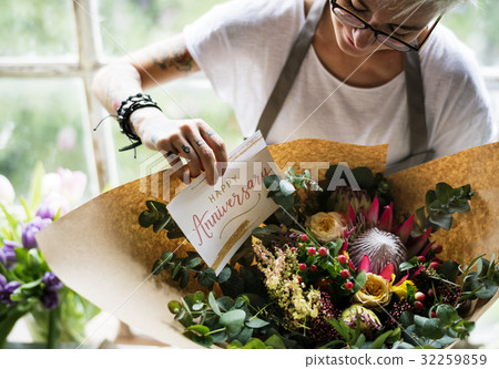 Florist Making Fresh Flowers Bouquet Arrangement with Happy Anniversary Card 32259859