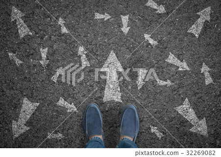 man standing on road with many direction arrow 32269082