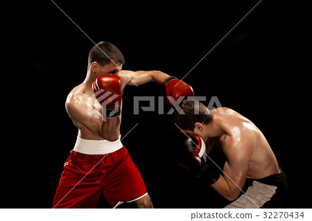 Two professional boxer boxing on black smoky Two professional boxer boxing on black smoky 32270434