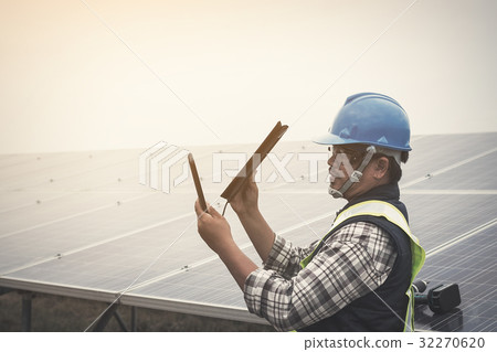 engineer charging his phone with small solar cell engineer charging his phone with small solar cell 32270620