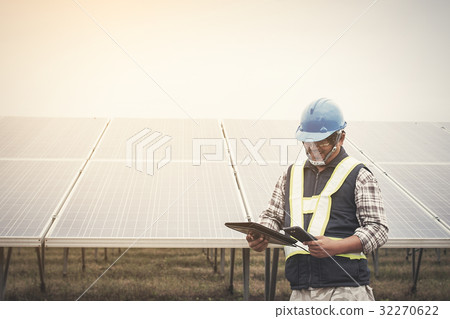 engineer charging his phone with small solar cell engineer charging his phone with small solar cell 32270622
