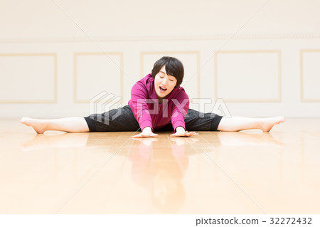 A young woman who bends forward leg flexion 32272432