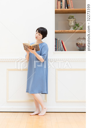 Young woman reading a book Young woman reading a book 32273399