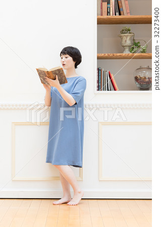 Young woman reading a book Young woman reading a book 32273400