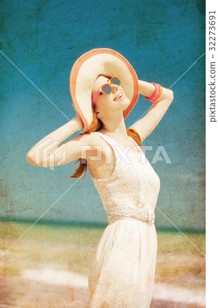 Young woman in hat and sunglasses at sea Young woman in hat and sunglasses at sea 32273691