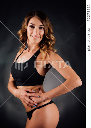 Young sexual woman in black underwear with a slim 32275311