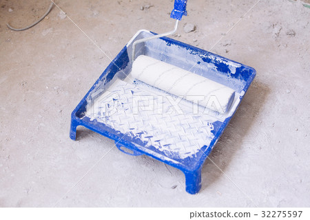 Bucket with paint and a brush roller paint tray 32275597