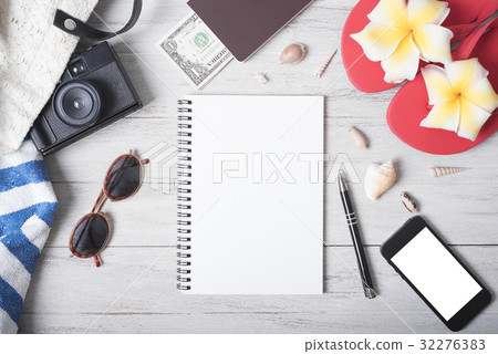 Holiday travel notebook with accessories on wood Holiday travel notebook with accessories on wood 32276383