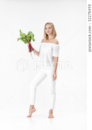 Beautiful blond woman holds beetroot with green Beautiful blond woman holds beetroot with green 32276459