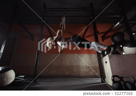 Fitness woman workout on the TRX in the gym Fitness woman workout on the TRX in the gym 32277102