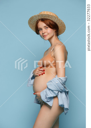 Young beautiful pregnant woman standing on blue 32277633