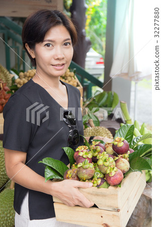 Asian woman with mangosteen fruit basket 32277880