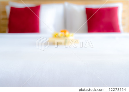 Blurred hotel room with bed and flower arrangement 32278334