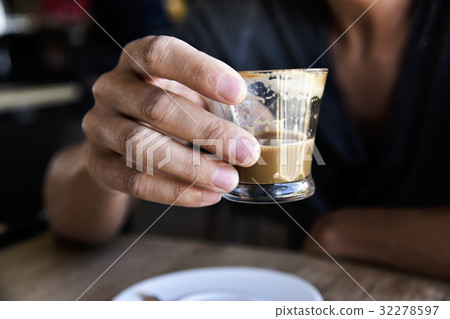 young man with a macchiato in a coffeehouse young man with a macchiato in a coffeehouse 32278597