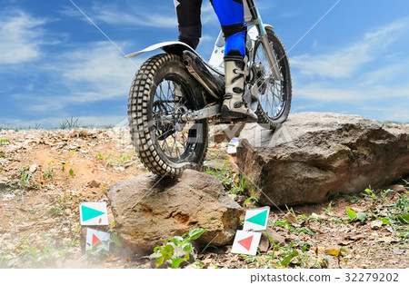 Trials motorcycle is jumping over rocks Trials motorcycle is jumping over rocks 32279202