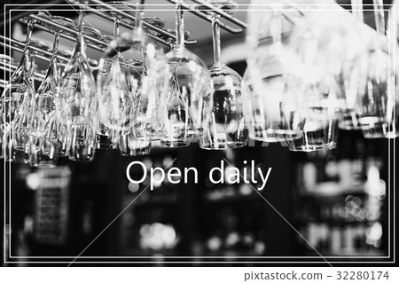 Open Daily.Empty glasses for wine above a bar rack 32280174