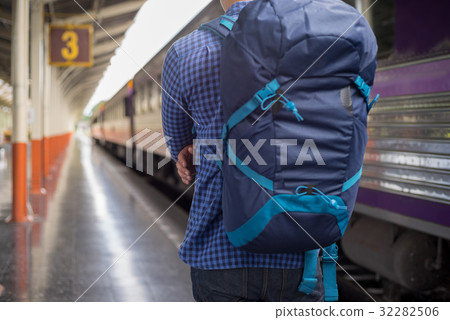 man traveler with backpacker at trainstation 32282506