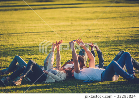 Multi-ethnic group of friends taking a selfie with 32283824