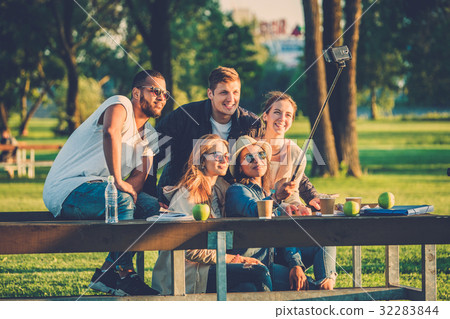 Multi-ethnic group of friends taking a selfie with 32283844
