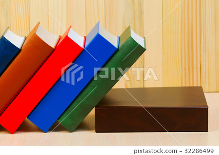 Stack of hardback books on wooden table. Back to Stack of hardback books on wooden table. Back to 32286499