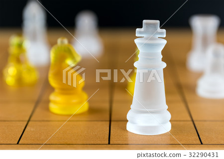 Chess glass on a wood chessboard 32290431